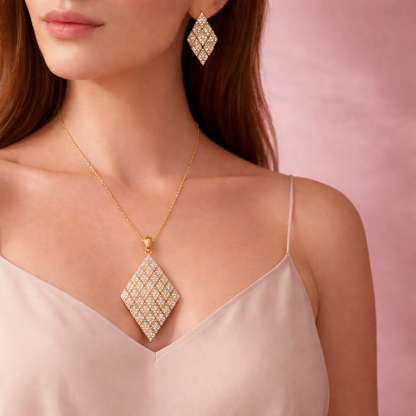 Woman wearing a gold necklace and earrings with a pink background